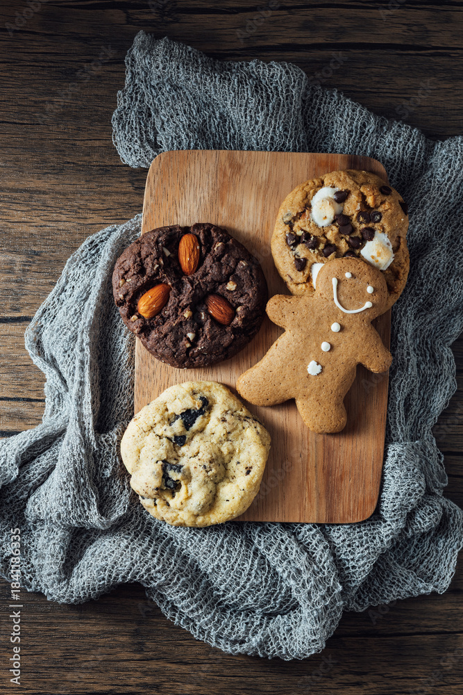 Fototapeta premium Delicious Assortment of Homemade Cookies on Rustic Wooden Board