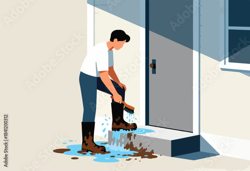 A person standing outside a door scrubs mud from a boot with a brush, water and mud puddles at feet