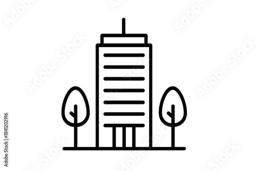 Tall building surrounded by trees in a city landscape during daylight hours