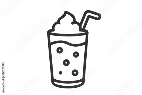 Drink with foam and bubbles in a glass with a straw served at a cafe on a sunny afternoon