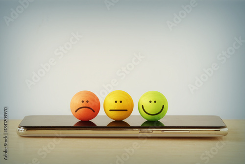 Red, yellow amd green faces with different facial expression on mobile phone - Concept of feedback and customer review