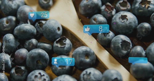 Like bubble popping, bubbles growing and floating over blueberries and spoon, showing engagement