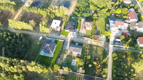 Aerial shot of forest edge village in autumn light