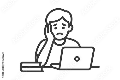 Student looks stressed while working on a laptop in a study space with books nearby during afternoon hours