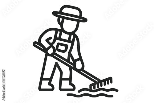 Agricultural worker wearing a sun hat and overalls using a long-handled rake for gardening