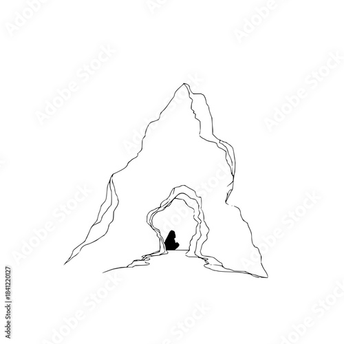 Person Standing in Cave Entrance on Mountain