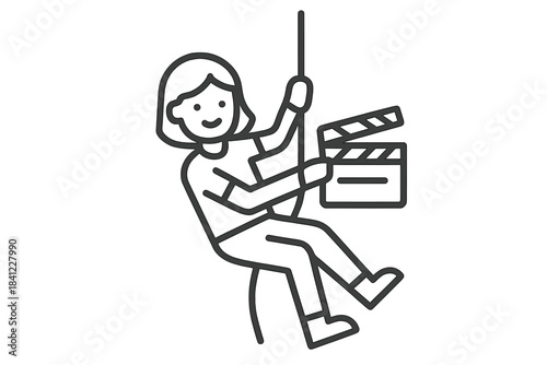 Stunt person suspended by cable holding a movie clapperboard during film production