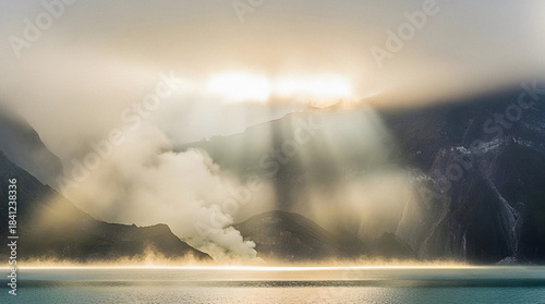 Golden god rays pierce through the mist of a Mount Rinjani Segara Anak Lake sunrise landscape creating a mystical mood