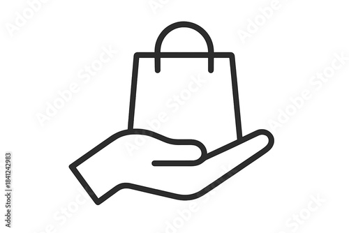 Hand holding a shopping bag symbolizing delivery service and online purchase fulfillment