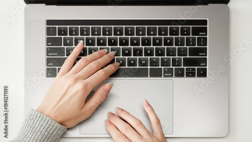 Close-up of a female hands on a laptop keyboard and touchpad browsing social networks, searching, and viewing online stores and marketplaces, modern internet usage concept.