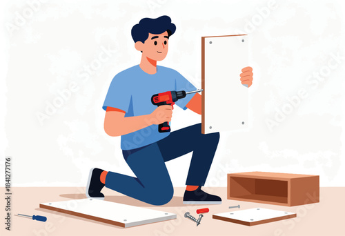 A person kneels, using a power drill to assemble furniture with wooden components