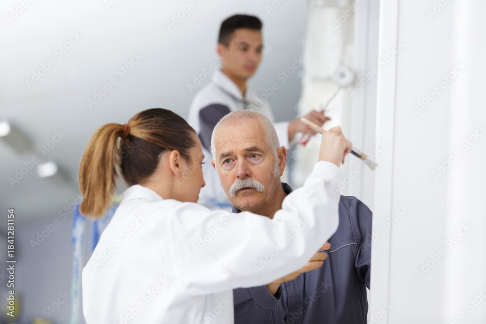 Fototapeta premium woman painting with teacher in workshop