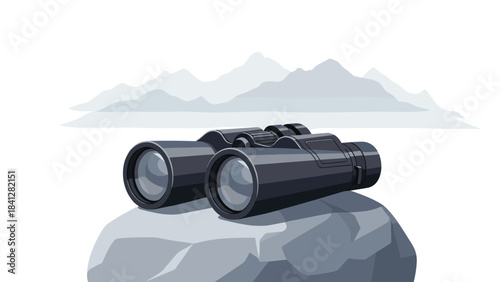 A pair of black binoculars on a rock with a mountain range in the background