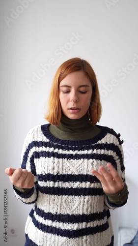 Caucasian woman with ginger hair actively talking and gesturing while counting on her fingers