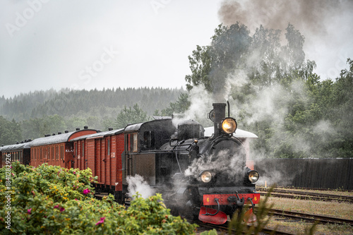 View of old steam train on track against sky