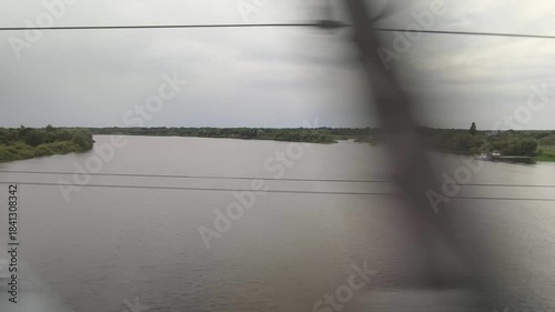 Train ride a river landscape with houses and trees