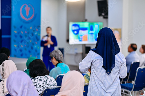 Photography Rear view of a questioner at an event , with a blurred background