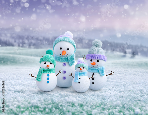 Snowman family wearing knitted hats and scarves in snowy field with soft whimsical lighting and falling snow