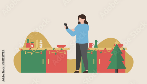 Woman using a phone in a festive kitchen preparing for holidays or shopping online