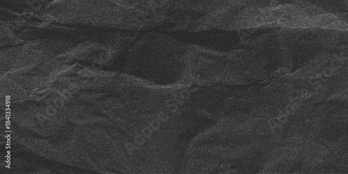 Distress overlay texture, dusty and gritty marks. Black crumpled paper surface with rough folds and subtle halftone noise, grunge backdrop.