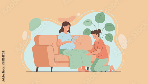 Pregnant woman uses a tablet supportive partner kneels beside her on the couch