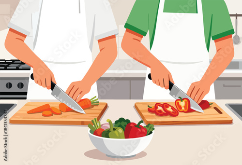 Two people in aprons preparing vegetables in a kitchen, one chopping carrots and the other bell peppers