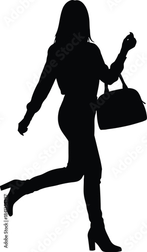 Silhouette of a stylish woman walking while carrying a handbag