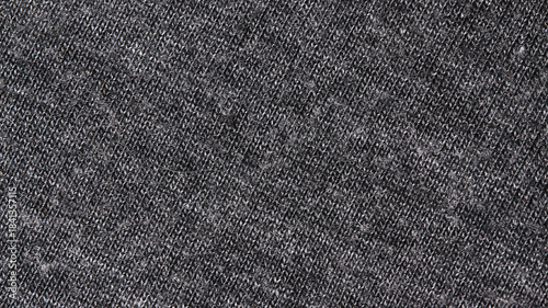 Close-up of a dark heather gray jersey knit fabric texture. This neutral, warm textile background is perfect for fashion, winter, and comfortable apparel concepts.