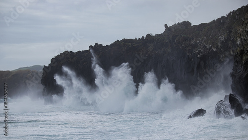 Fototapeta Naklejka Na Ścianę i Meble -  Stormy sea crashing against the rocky coast. Stormy day in the Atlantic Ocean near the Azores.