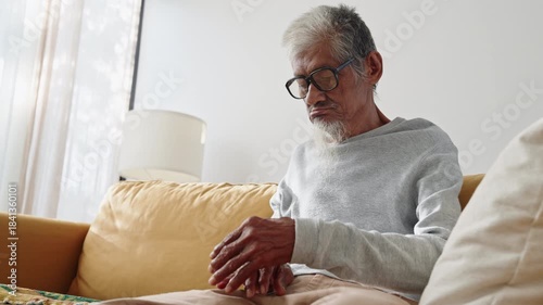 Elderly. Asian man gray hair physical therapy with finger massage, stretching for aches pains at home