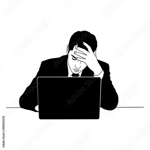 Stressed businessman holding head while working on laptop.