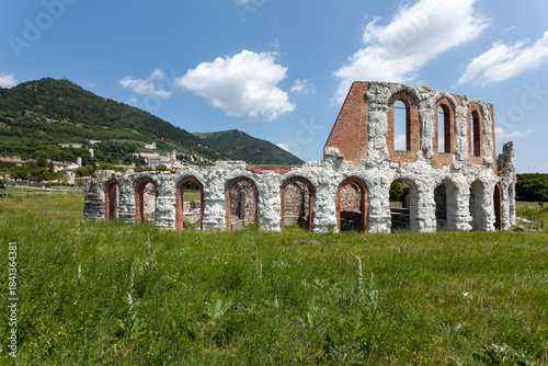фотографія View of the ancient Roman theatre ruins in Gubbio, Umbria—arched stone structures set in a green landscape