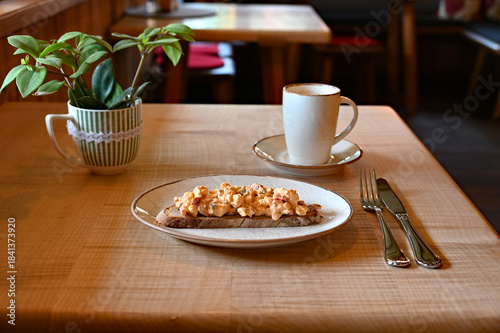 delicious traditional rustic Bavarian cheese called Obazda on the piece of the rustic bread wooden table at an alpine cafe in the Bavarian Alps	
