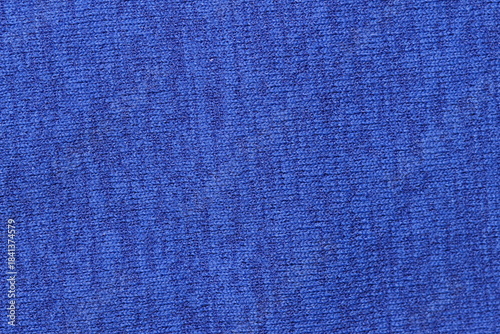Bright royal blue knit fabric texture close-up. Vibrant solid color textile background for fashion, design, and upholstery concepts.