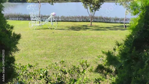 white metal bicycle decorating at waterside of pond lake 