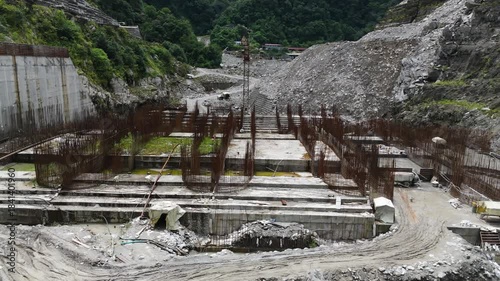 Heavy Construction Industry in Nepal: Aerial Perspective of Arun III Hydropower Site featuring Cranes Excavators and Rebar Framework for Mega Power Plant
