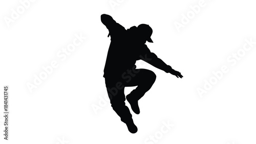 Silhouette of a young man breakdancing or performing hip hop dance moves in an energetic pose