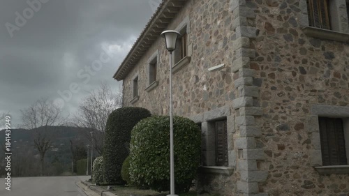 Stone house Polecam jib street lamp bushes plants windows up low