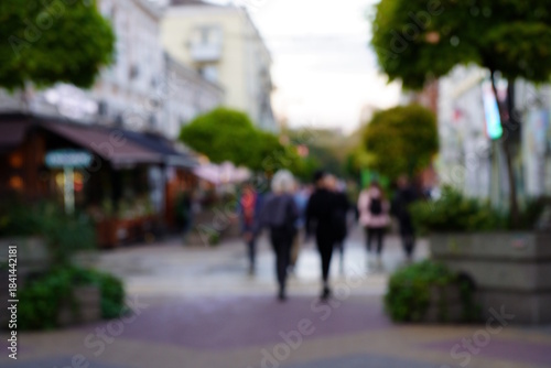 Abstract blurred background. A group of people is walking down the street.