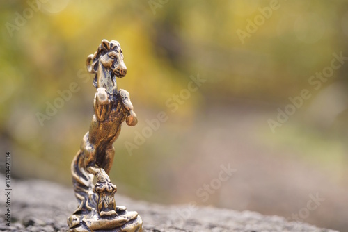 A statuette of a metal horse. A close-up figure.