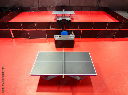 Fotografía Two Black table tennis or pingpong tables is settle on a red, orange floor of th