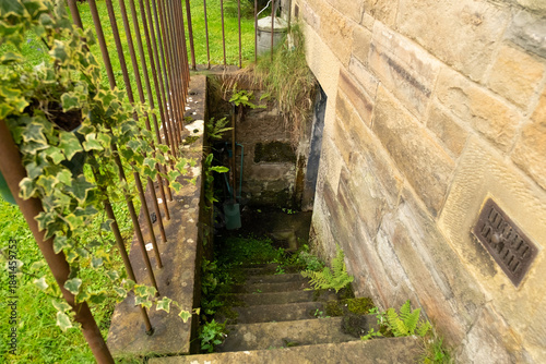 Canvas Print Damp stone steps down to basement outside old tenement building, in the Victoria