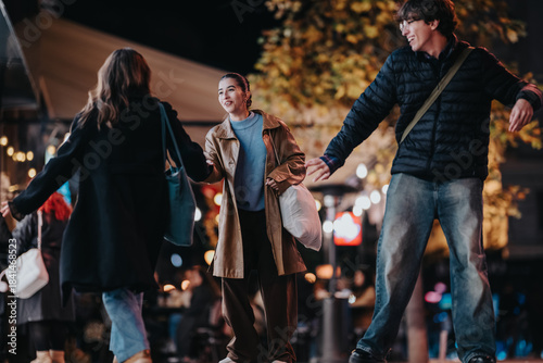 Tableau sur toile A group of friends share a joyful moment on a lively city street at night
