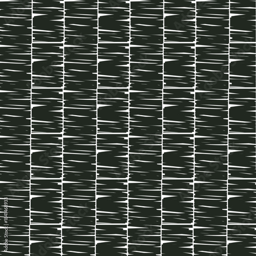 A dark, dense texture or surface composed of cut pieces, simulating a rug, plant cover, or patterned tiles.