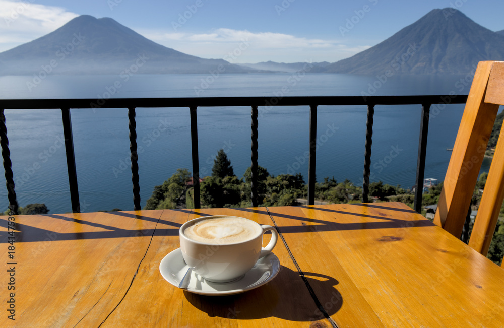 custom made wallpaper toronto digitalcoffee cup on table with scenic view lake atitlan antigua guatemala blue water sunny volcano crater pond outdoor travel tourism adventure getaway cappuccino late milk cafe restaurant flavor santa cruz