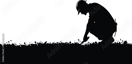 Silhouette of a worker or surveyor crouching down to examine or work on the ground with a tool, symbolizing construction, archaeology, mining, detailed inspection, and manual labor.