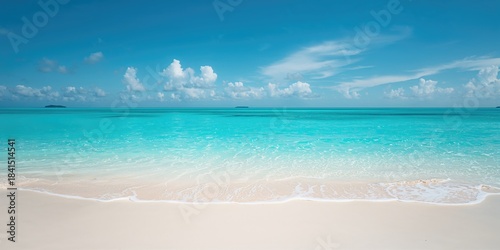 Fototapeta Naklejka Na Ścianę i Meble -  Serene blue ocean surf on sandy shoreline used as a backdrop for editorial or UI design, summer setting