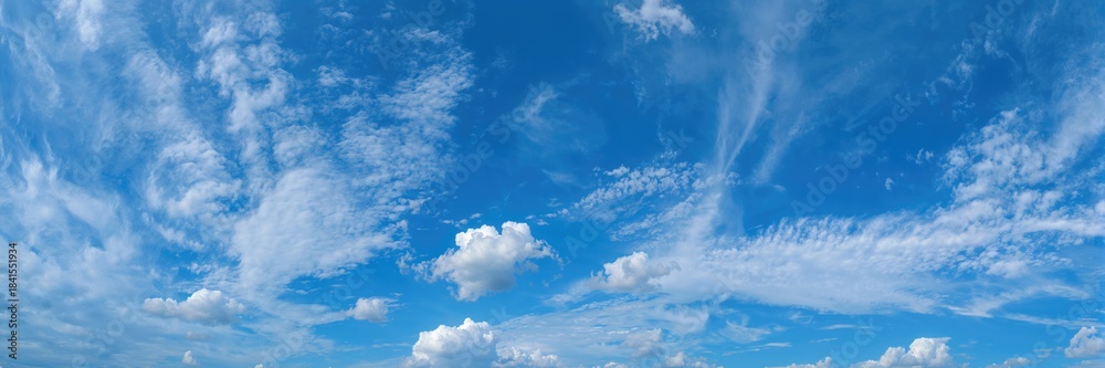 Fototapeta premium Wide-angle shot of a gentle cloudscape in the sky, ideal for editorial header backgrounds