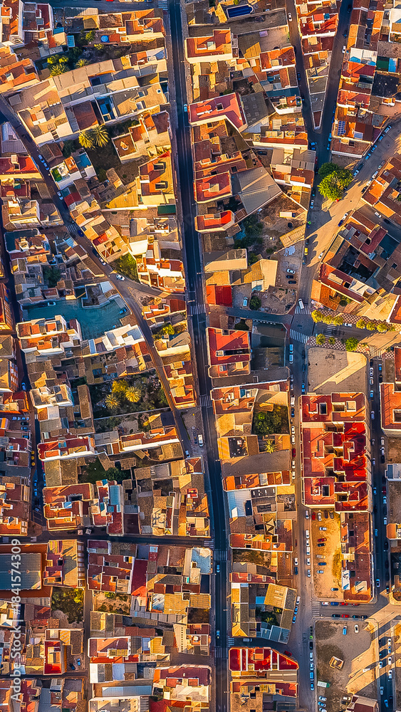 Fototapeta premium Illuminated urban grid of Getsemani Cartagena Colombia. Colorful rooftops and evening streets. Dron.