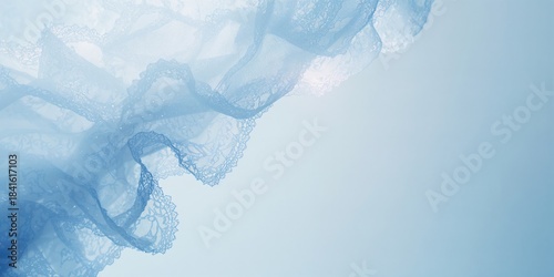 Soft-focused translucent lace material in light blue shades, used in high-end fashion and textile projects